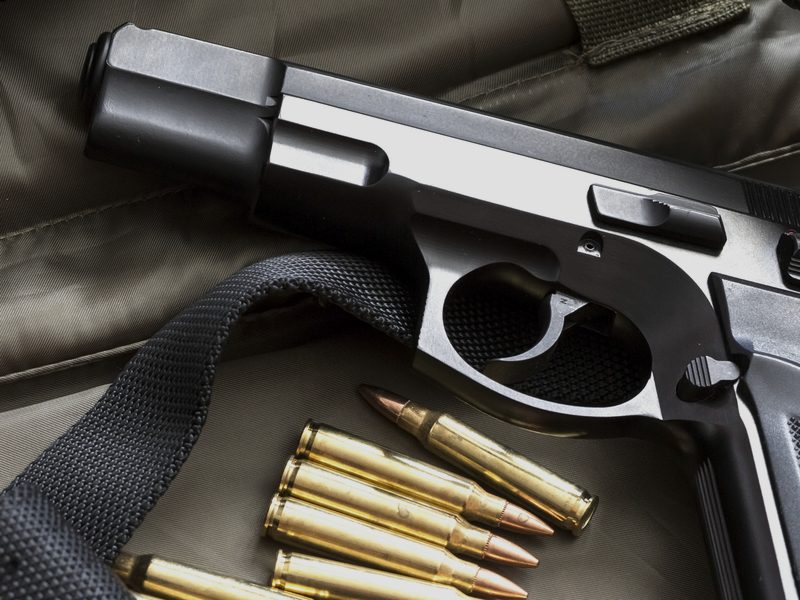 Handgun with ammunition on a range bag — Illinois concealed carry class equipment